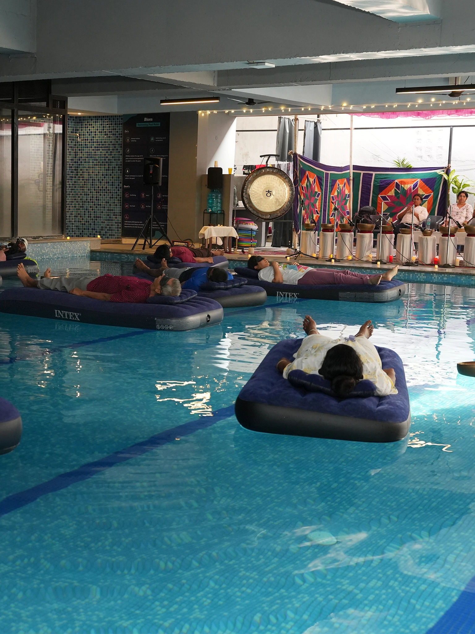 Person floating in water during aqua sound bath meditation with soothing sound vibrations
