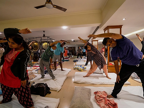 A participant gently stretching to release tension and welcome inner calm and openness