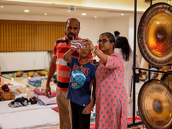 Family members connected deeply through shared energy balancing and heart-centered exercises