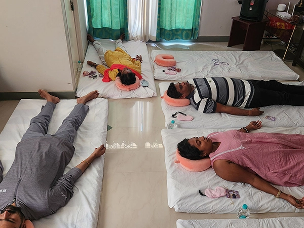 Facilitators use the gongs to lead the sound bath session for participants seeking deep relaxation