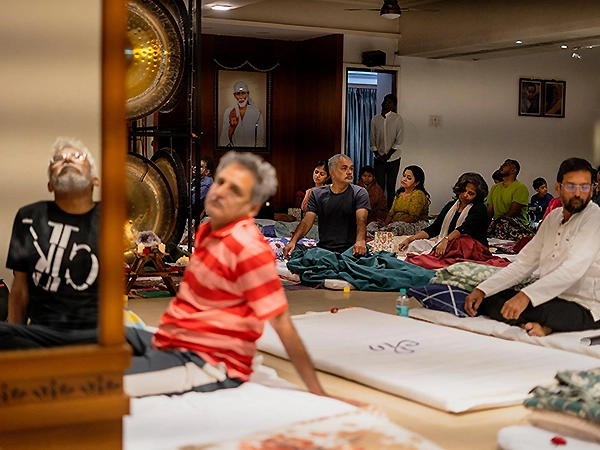 Group immersed in a gong meditation session promoting profound inner peace and mental clarity