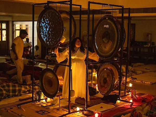Practitioner using focused gong rhythms to activate holistic healing and restore energetic balance