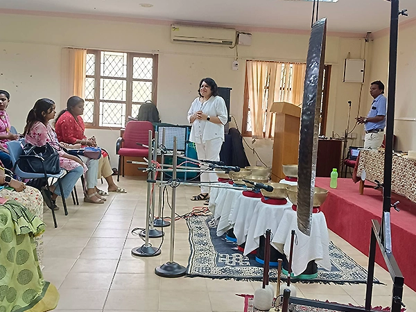 Gong bath demonstration presented at a college wellness event to promote inner peace and balance.