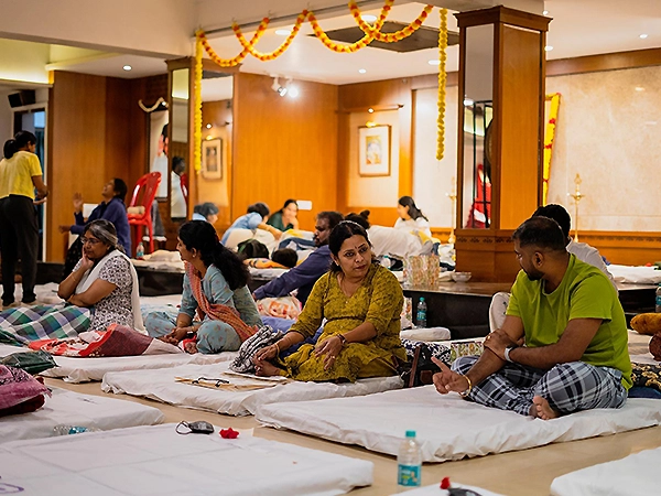 Individuals seated in deep meditation, focused on breath, calm, and collective stillness