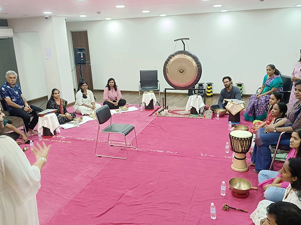 Practitioners guide holistic sound therapy using gongs to restore mind body balance and energy flow