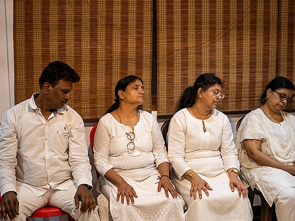 Participant engaged in quiet meditation in a serene and spiritually focused environment