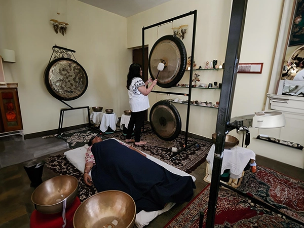 Healing session moments with Santhoshi focused on emotional and energy wellness.