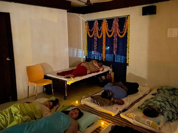 Peaceful setting and serene expressions during Satvat Dhwani Nidra meditation event