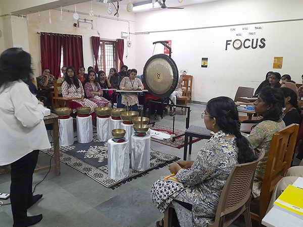 Students explore & engage in Tibetan singing bowls during sound meditation at the Madras University