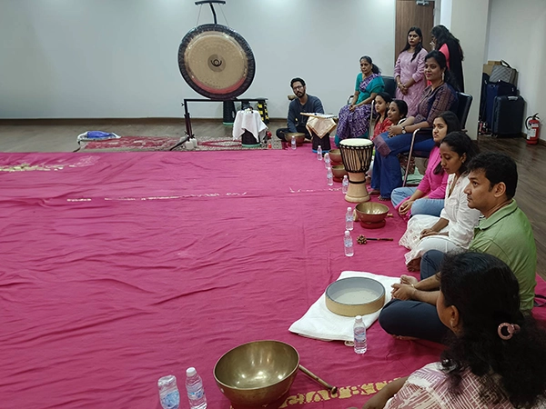 Therapists lead a wellness-focused gong bath session to balance energy and improve emotional clarity