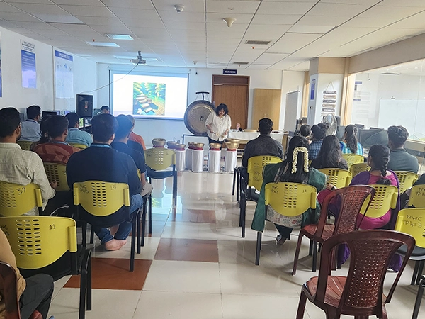 A wellness-focused yoga guidance session structured and facilitated on open campus lawn at SRM.